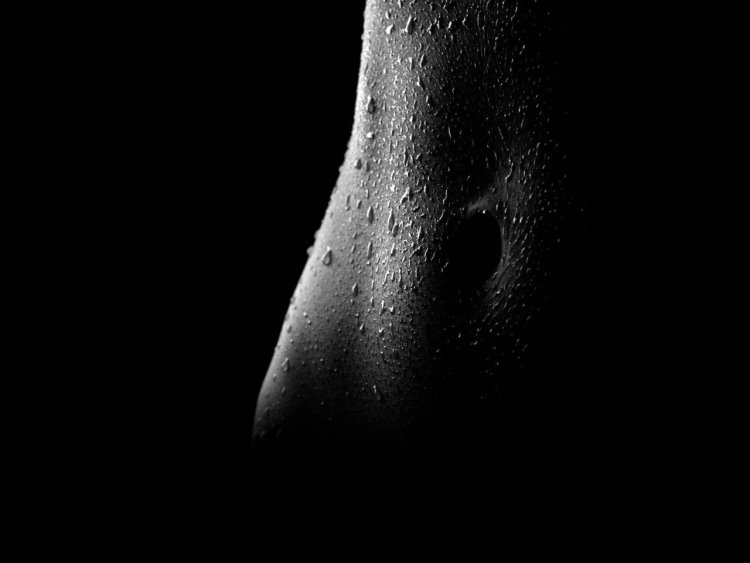 Female body on a dark background