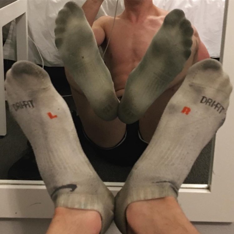 Foot in socks to a guy