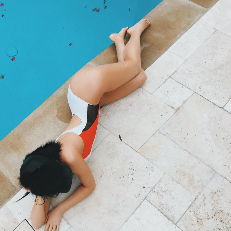 Photo by Kylie Jenner in a black swimsuit lying on his back