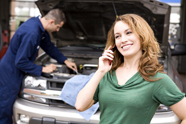 A woman in a car repair shop