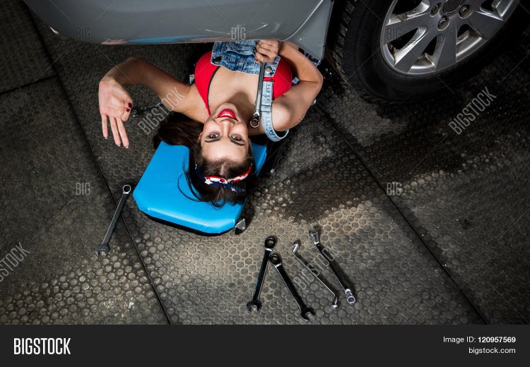 The girl is repairing the car