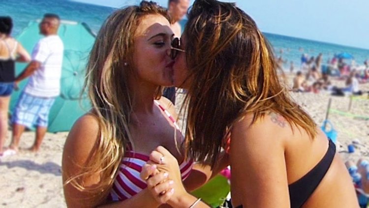 Two girlfriends beach kisses