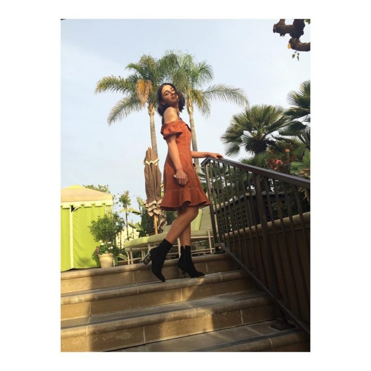 Naomi Scott in a jasmine swimsuit