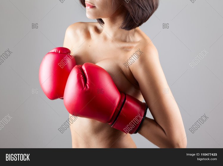 Girl in boxing gloves covers her chest