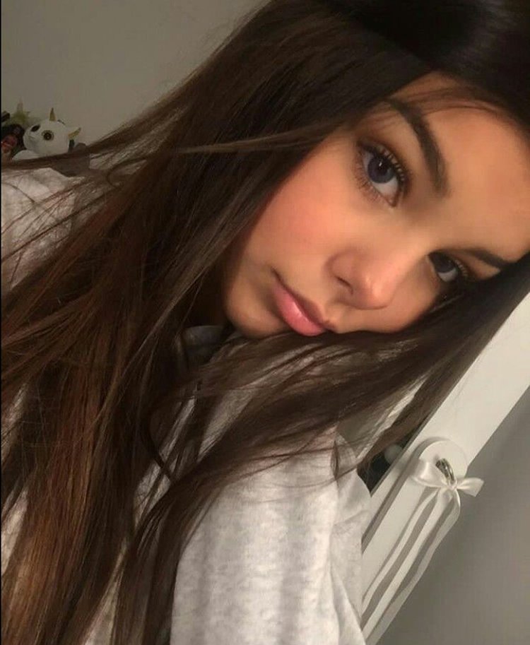 Girl with dark hair at home