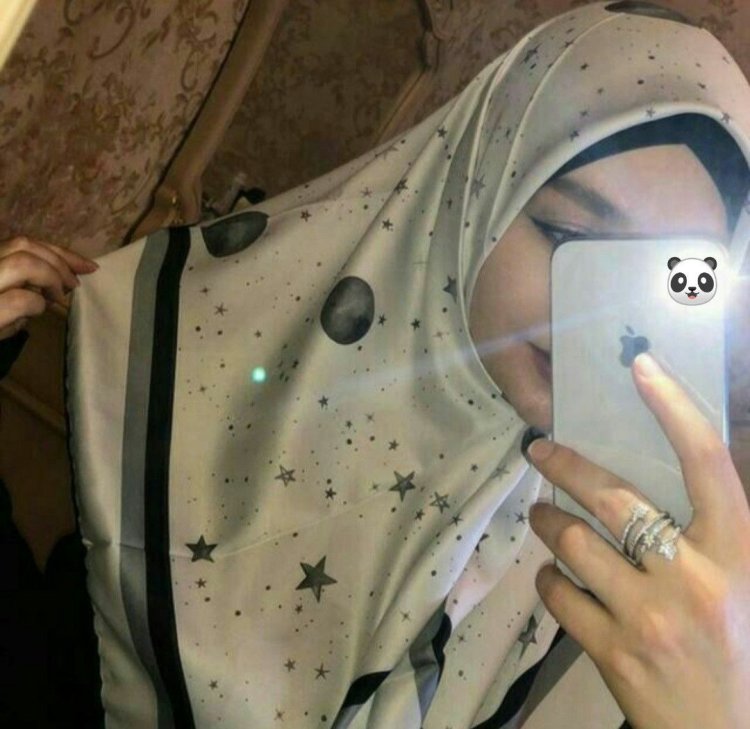 Girl in a hijab in a mirror