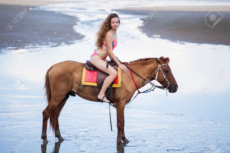 Bikini women riding a horse