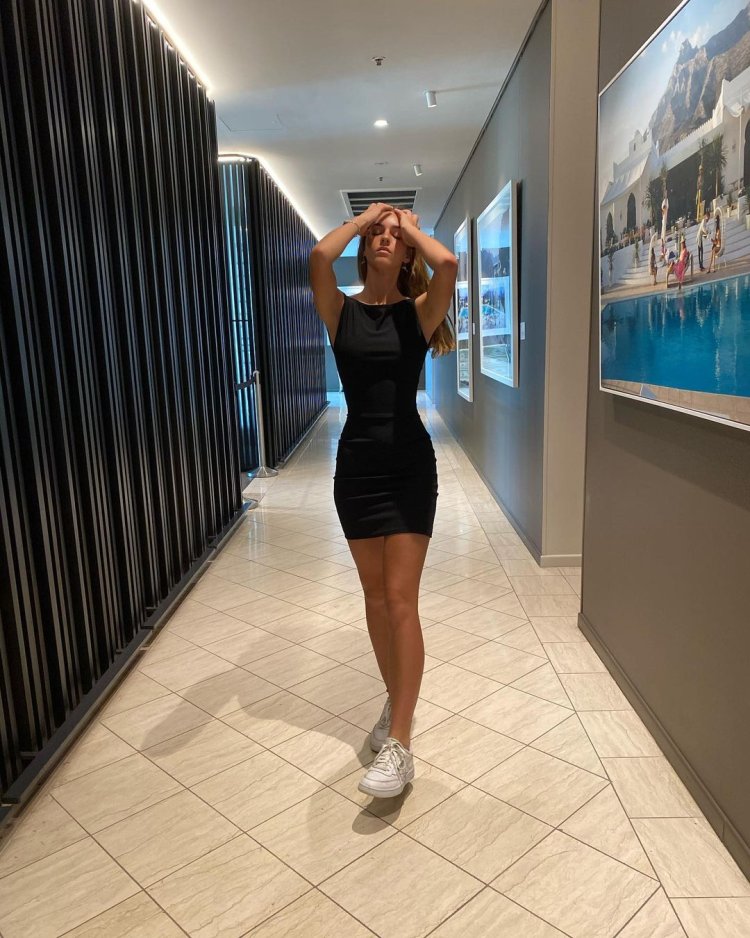 Emily Feld in a dress