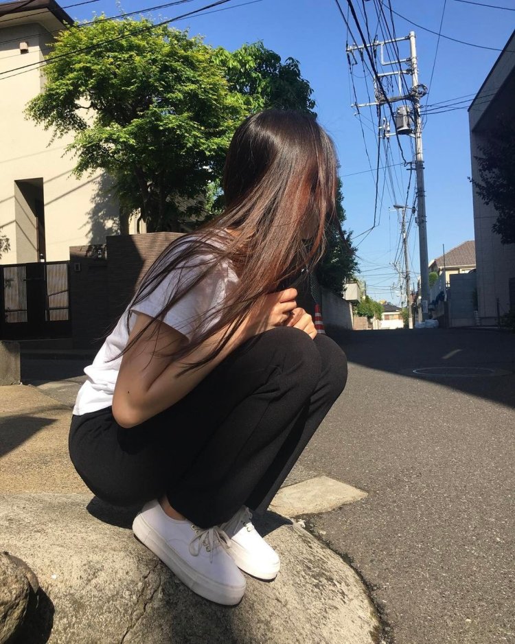 Girl with dark hair on the street