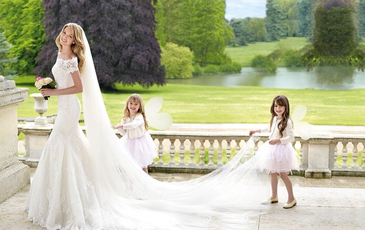 Children in wedding dresses with a veil