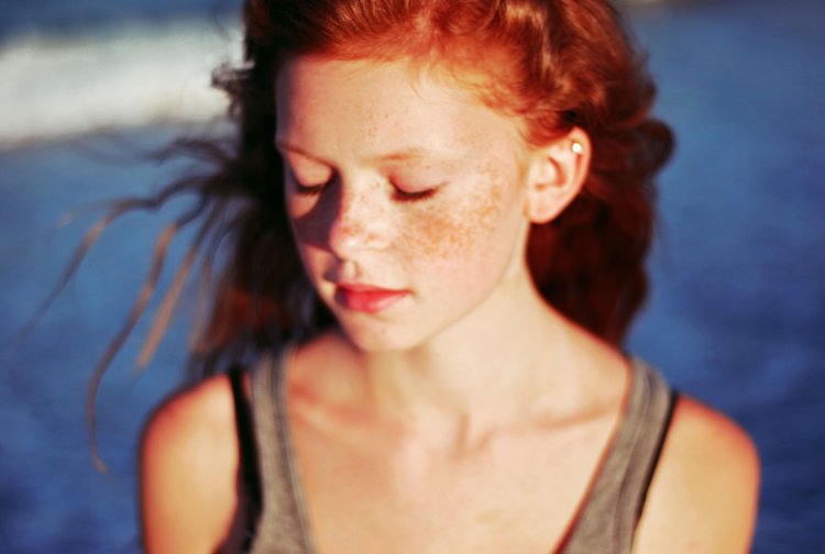 Red -haired curly girl teenager
