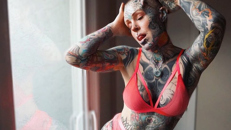 The girl is all in tattoos and piercing
