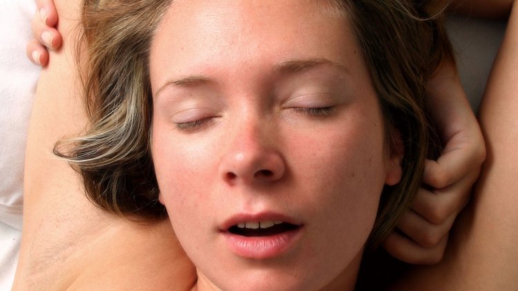 The face of a moaning woman