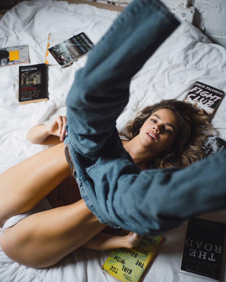 Girl in jeans on the bed