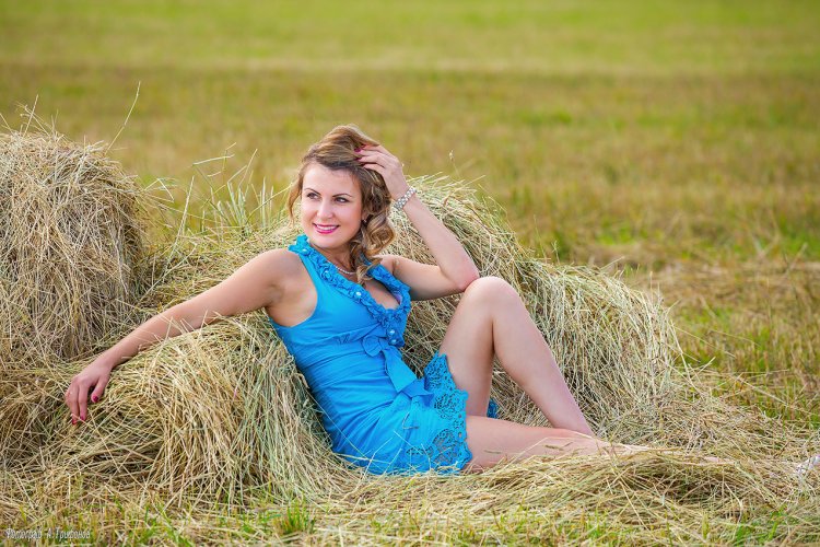 Girl on the hay in the sundress