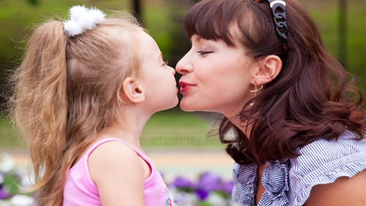 Girl kissing mom