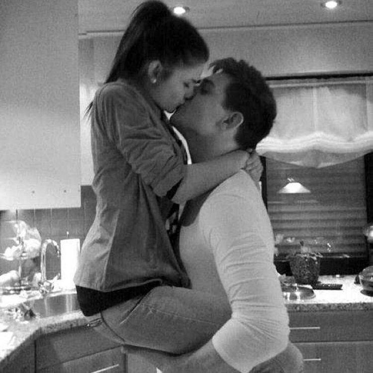 The guy hugs and kisses the girl