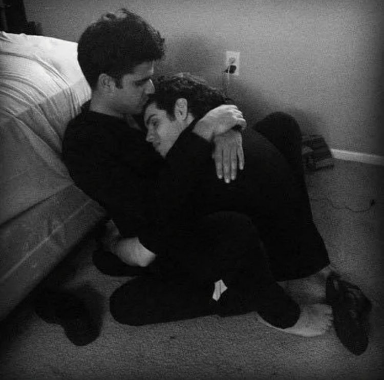 Two guys hugging without a face