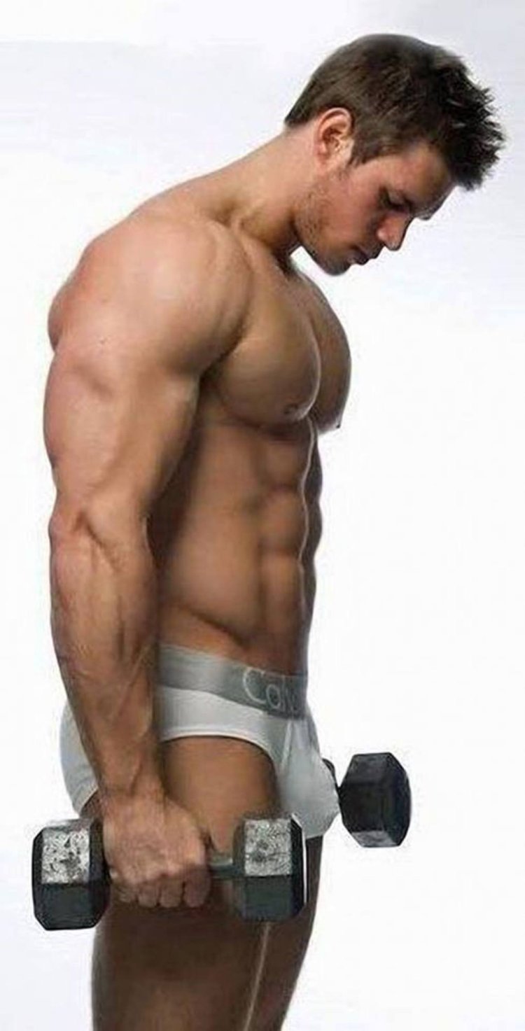 Muscular guy takes off his helmet