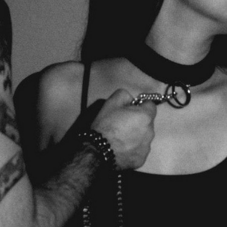 Guy in a collar with a leash