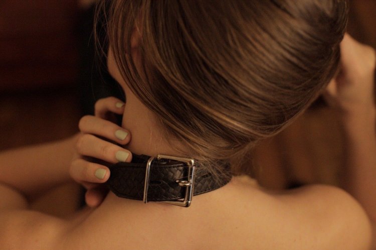 Girl with a belt around her neck