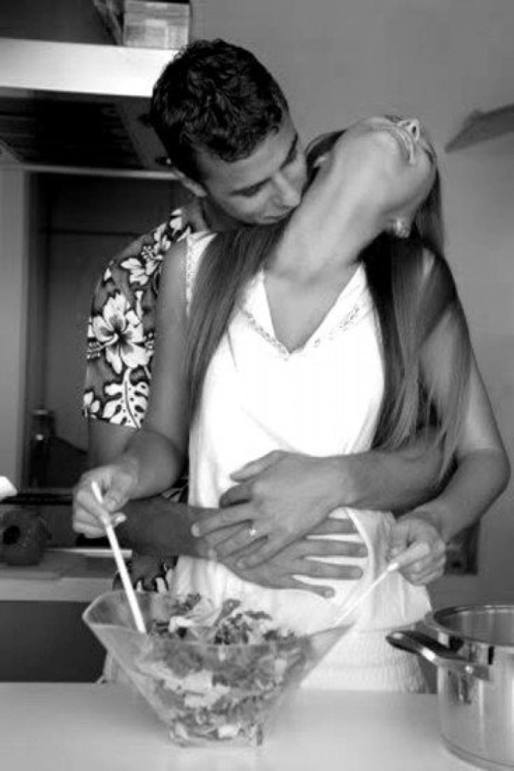 Guy hugging in the kitchen