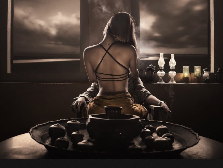 Woman on the table in front of the man