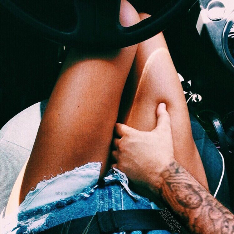 Man's hand on his knee in a car