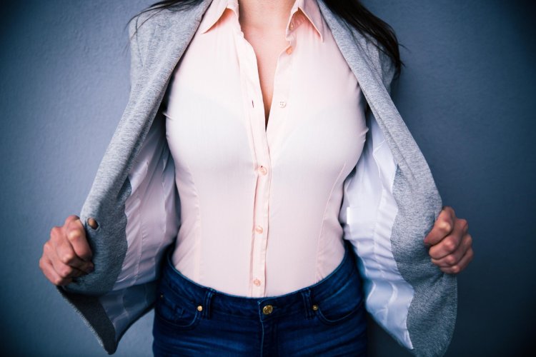 Woman unbuttoning her blouse