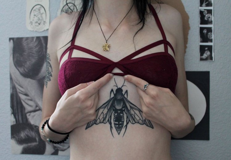 Butterfly tattoo under chest