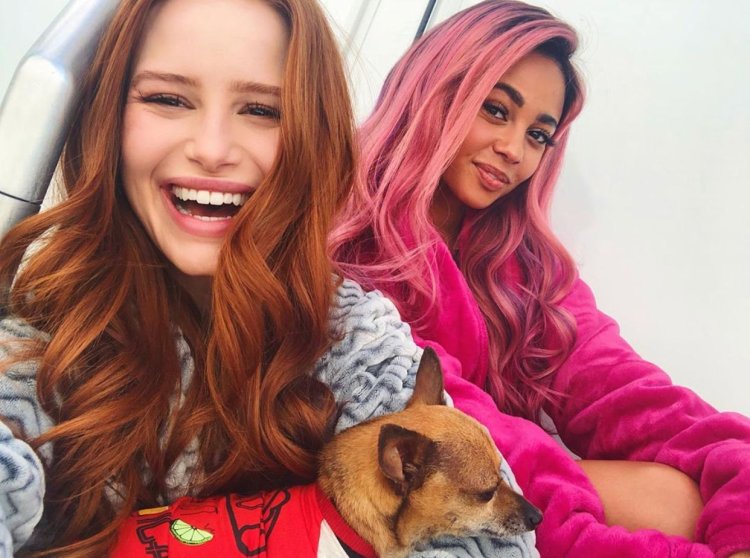 Medklin Petsch and Vanessa Morgan in Christmas costumes