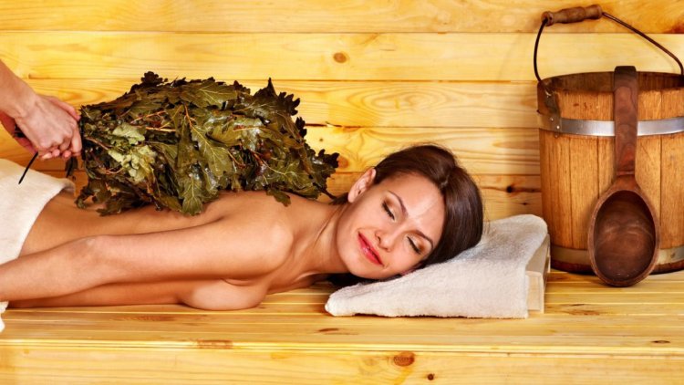 Girl in a steam room with a broom