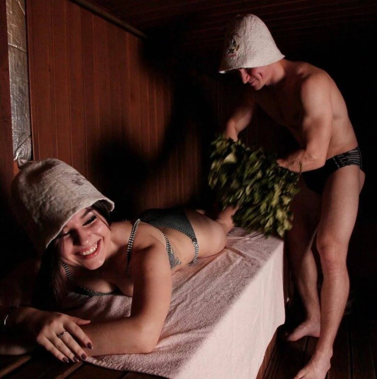 Girl in the sauna with a broom
