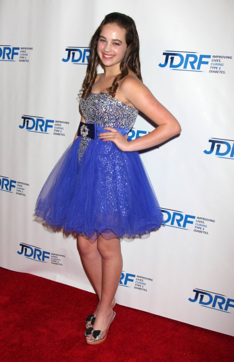 Mary Mouser in a dress