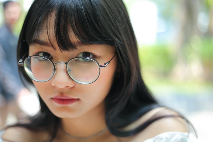 Photo of a girl with bangs in glasses