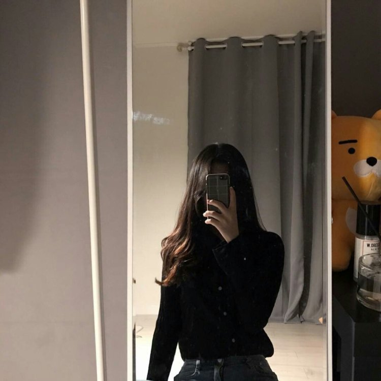 Girl with dark hair in the mirror