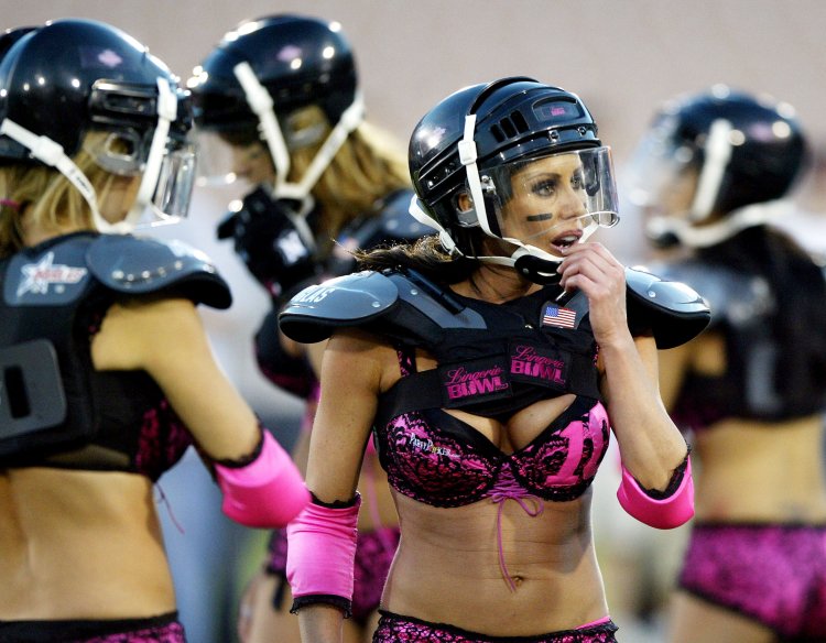 Woman wearing american football helmet