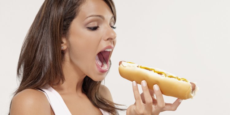 Girl eating hot dog
