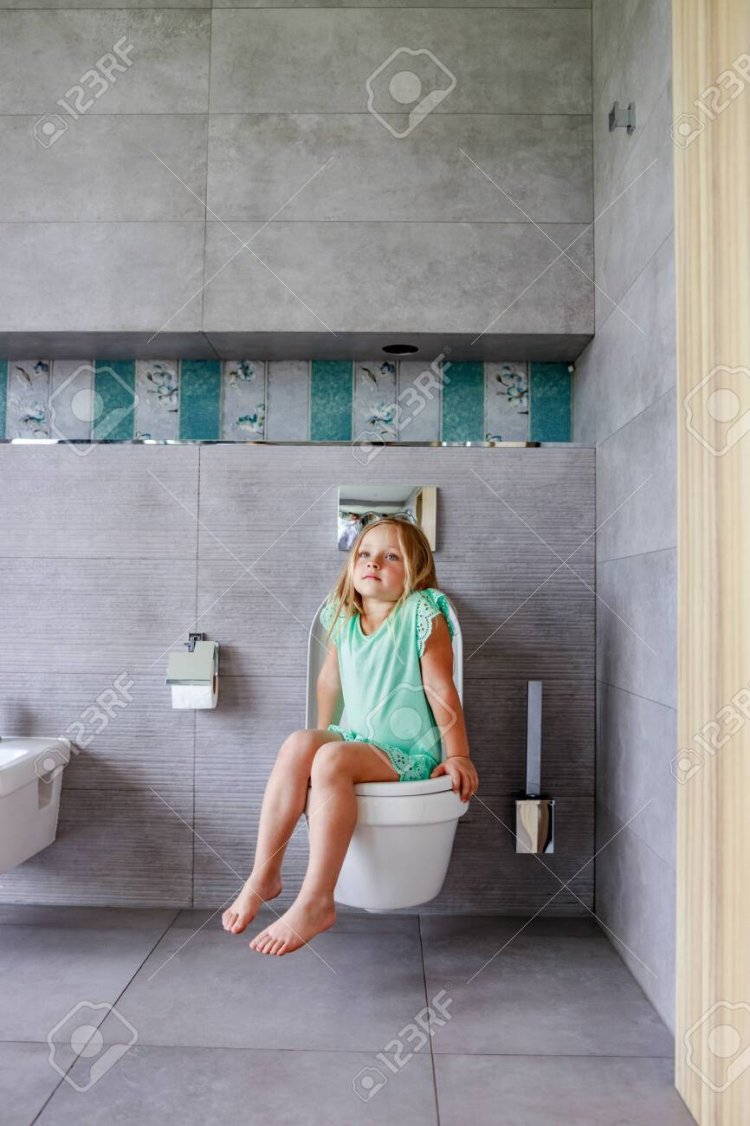 Girl pushing on the toilet