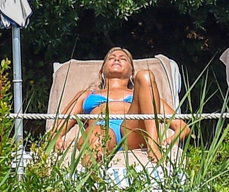 Jennifer Aniston in a swimsuit on a sun lounger