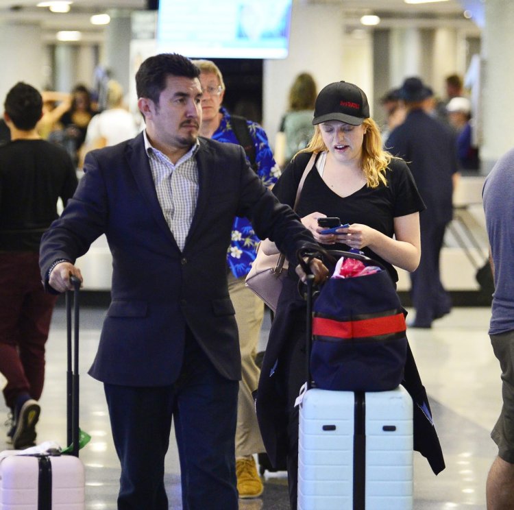 Max Minghella and Elisabeth Moss kiss