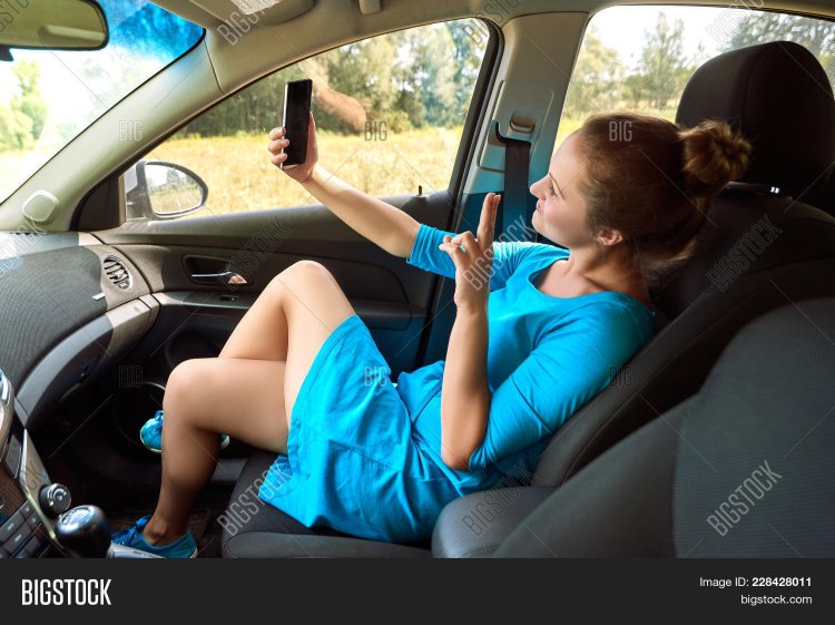 The girl in the front seat of the car