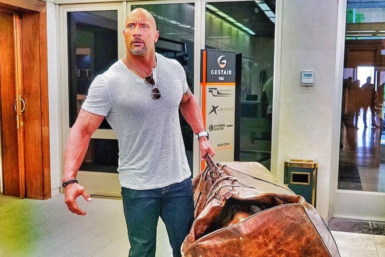 Dwayne Johnson with a big bag