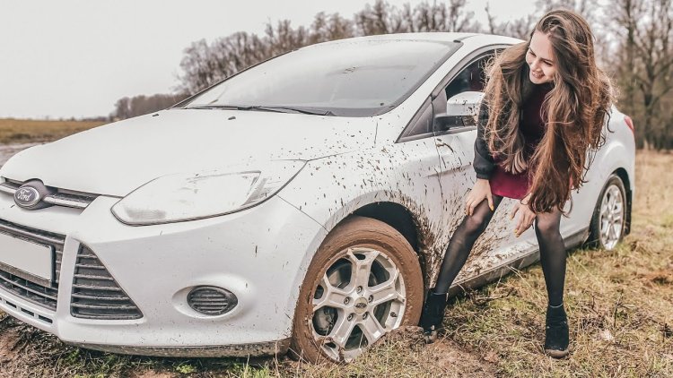 Girls stuck in a car in a field