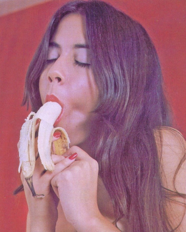The girl licks the banana