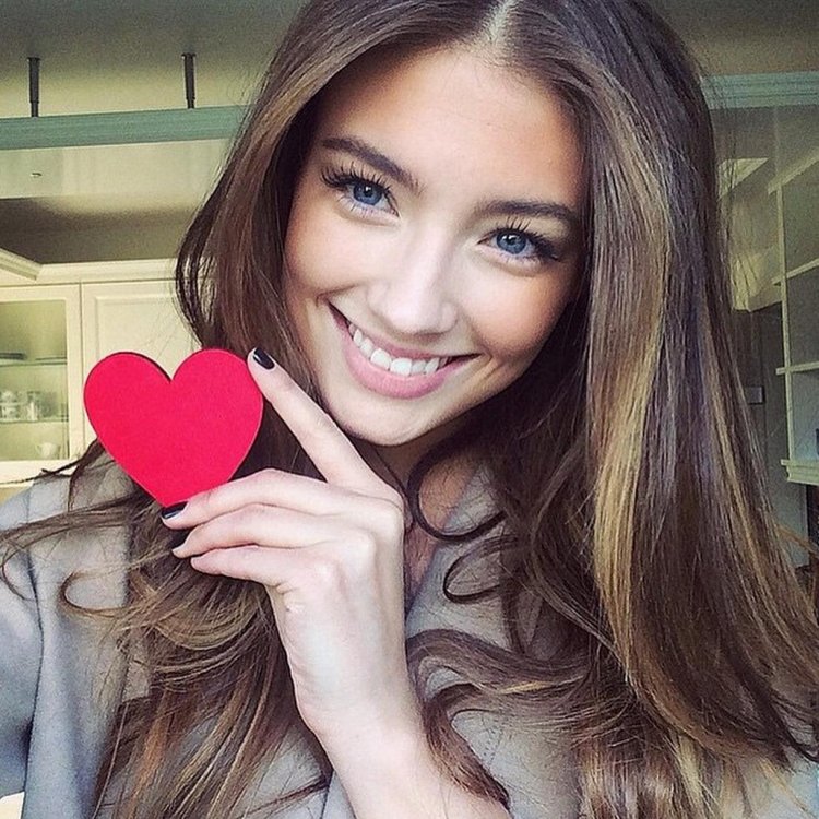 The girl smiles at a selfie