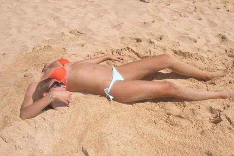 Funny sunbathing on the beach