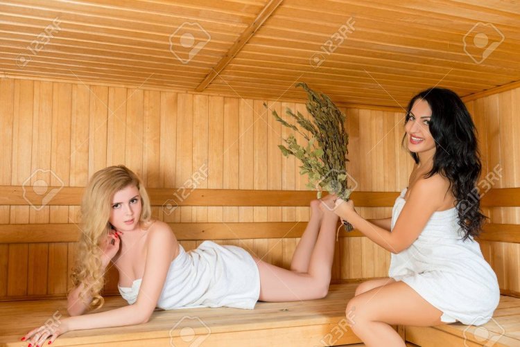 Girls in the steam room with brooms
