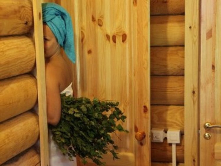 Girl in a steam room with a broom