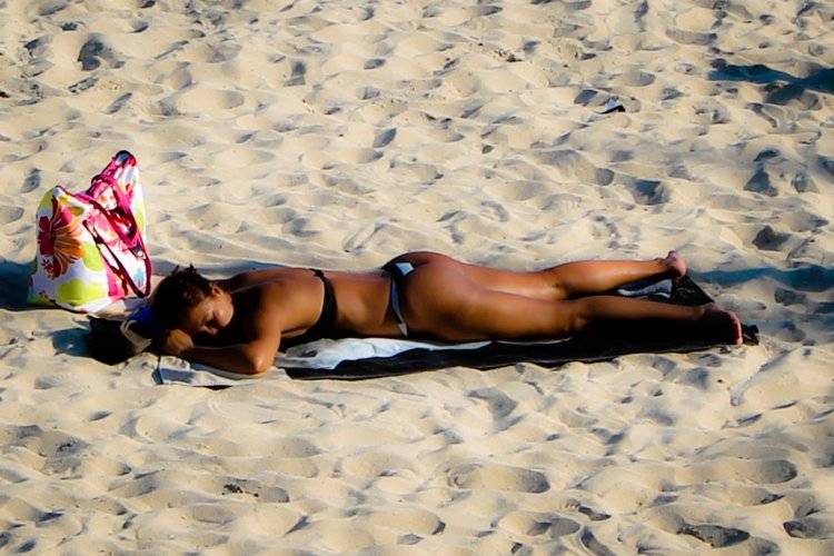 Girls sunbathe on the beach